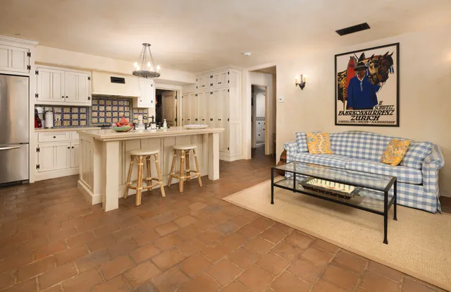 a living room with stainless steel appliances kitchen island granite countertop furniture and a kitchen view