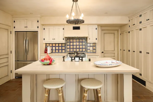 a kitchen with stainless steel appliances a dining table and chairs