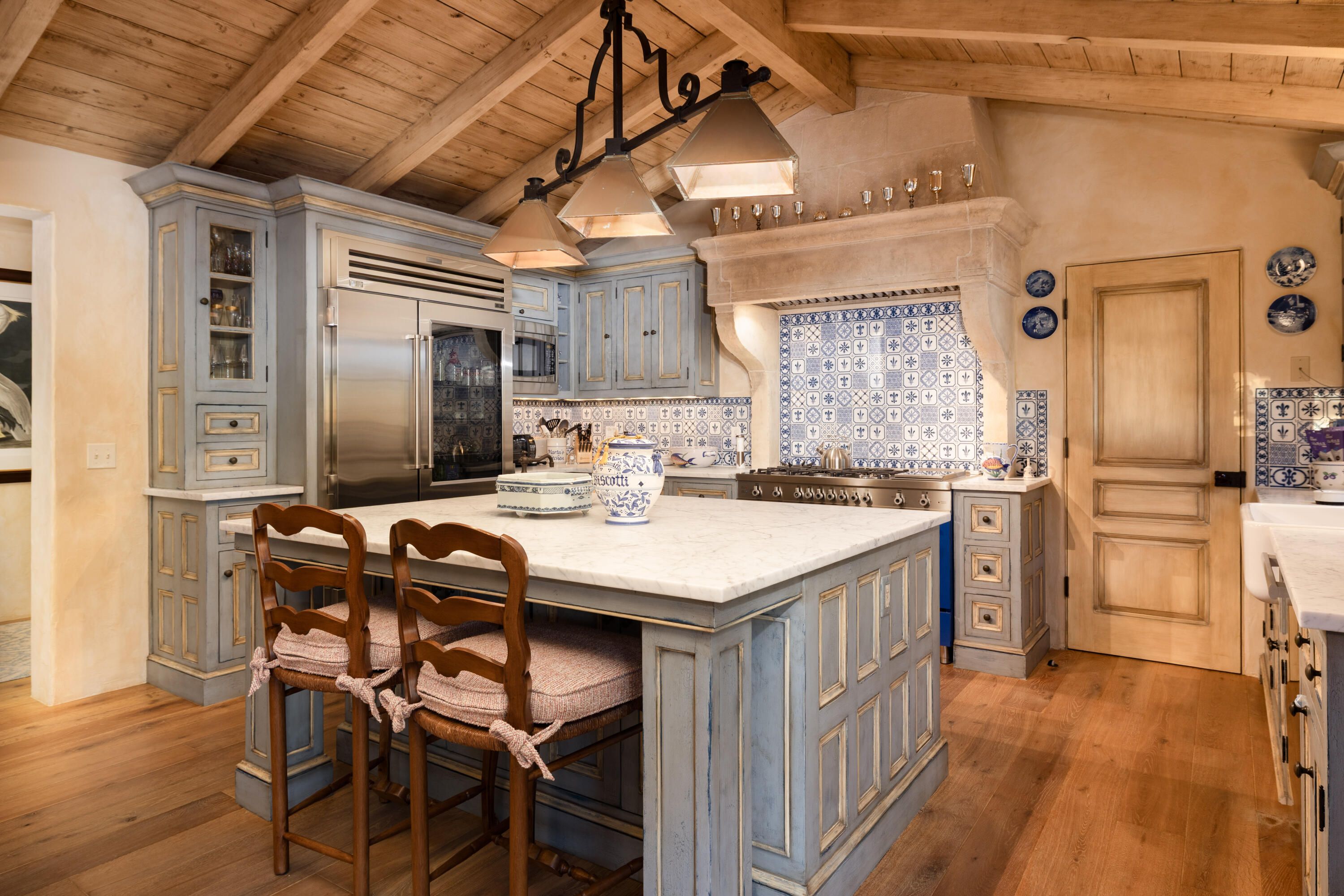 965 Brooktree Road Montecito, CA 93108 - Photo 9 of 26 a kitchen with a table chairs refrigerator and cabinets