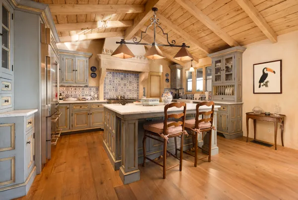 a kitchen with a sink a counter space appliances and cabinets