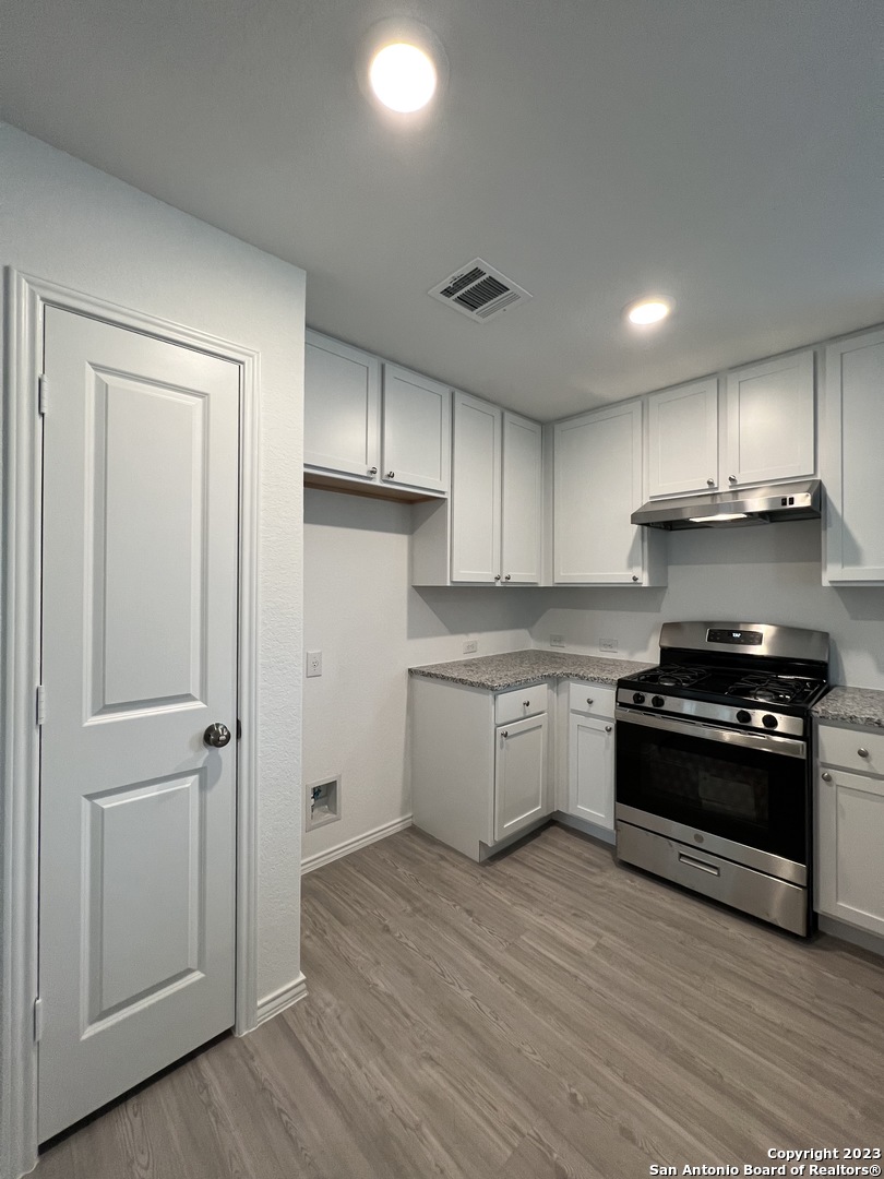 13819 Llama Place San Antonio, TX 78252 - Photo 15 of 37 a kitchen with a stove a refrigerator and a sink