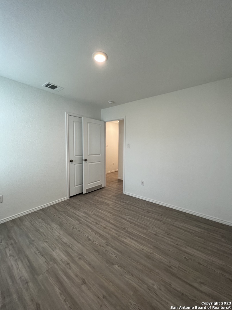 13819 Llama Place San Antonio, TX 78252 - Photo 19 of 37 a view of an empty room with wooden floor and window