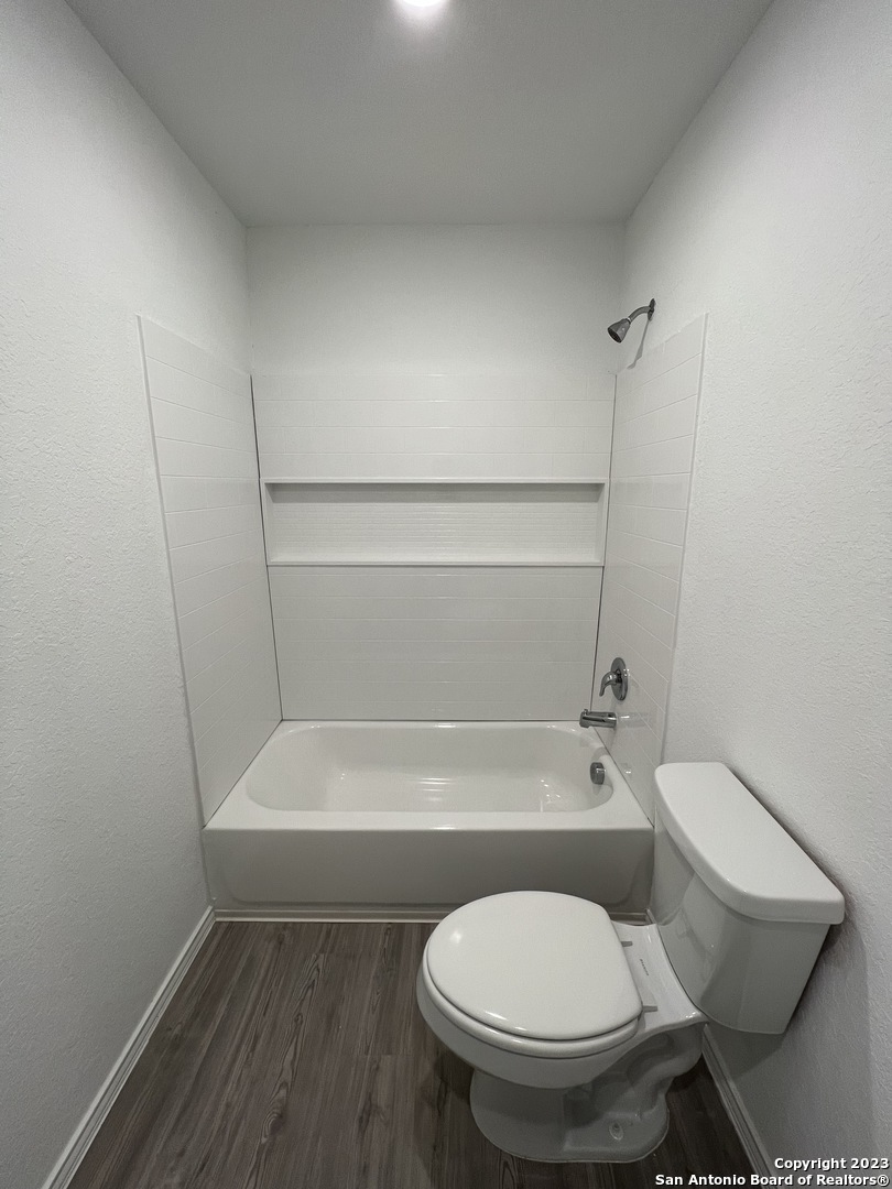 13819 Llama Place San Antonio, TX 78252 - Photo 21 of 37 a white toilet sitting next to a bathtub