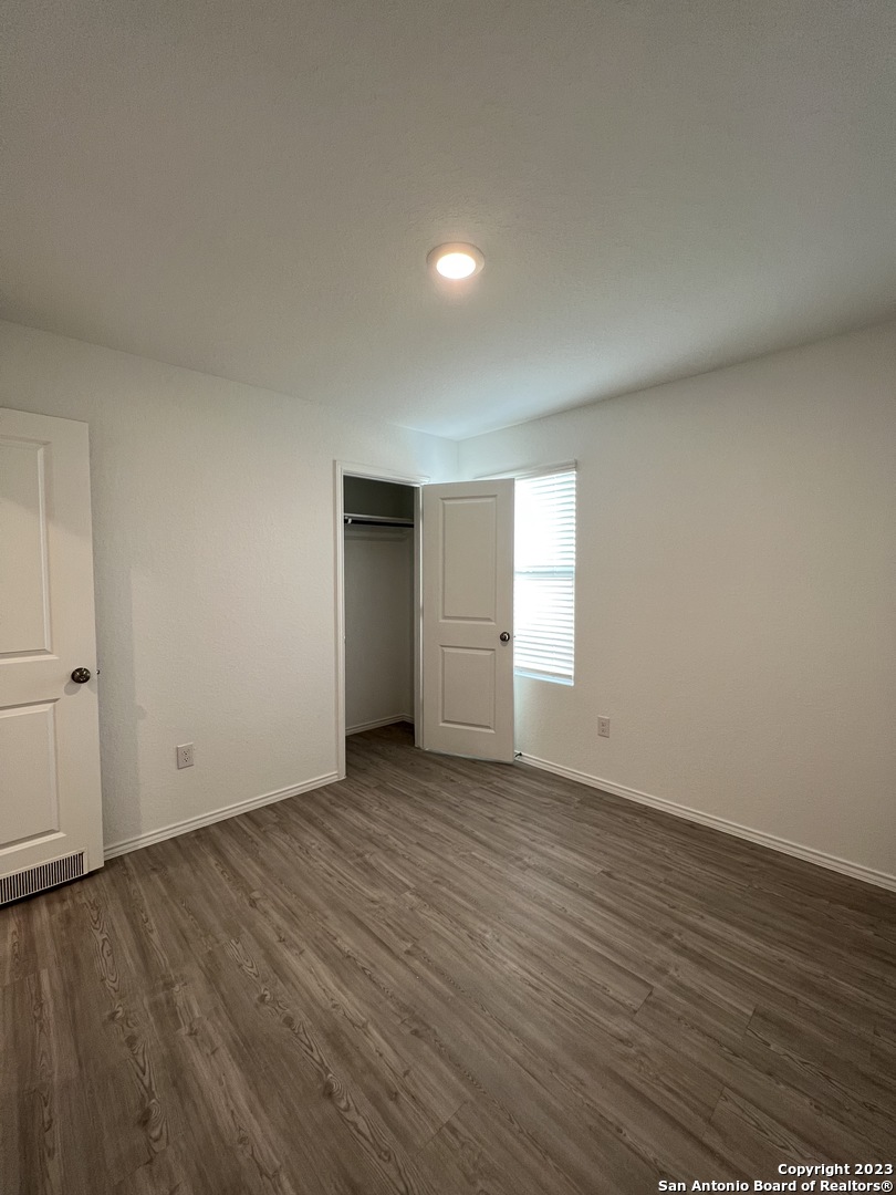 13819 Llama Place San Antonio, TX 78252 - Photo 24 of 37 a view of an empty room with wooden floor and window