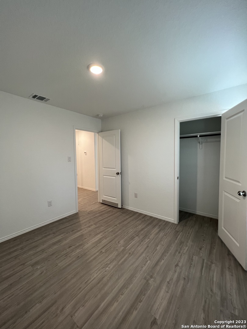 13819 Llama Place San Antonio, TX 78252 - Photo 25 of 37 a view of an empty room with wooden floor and closet