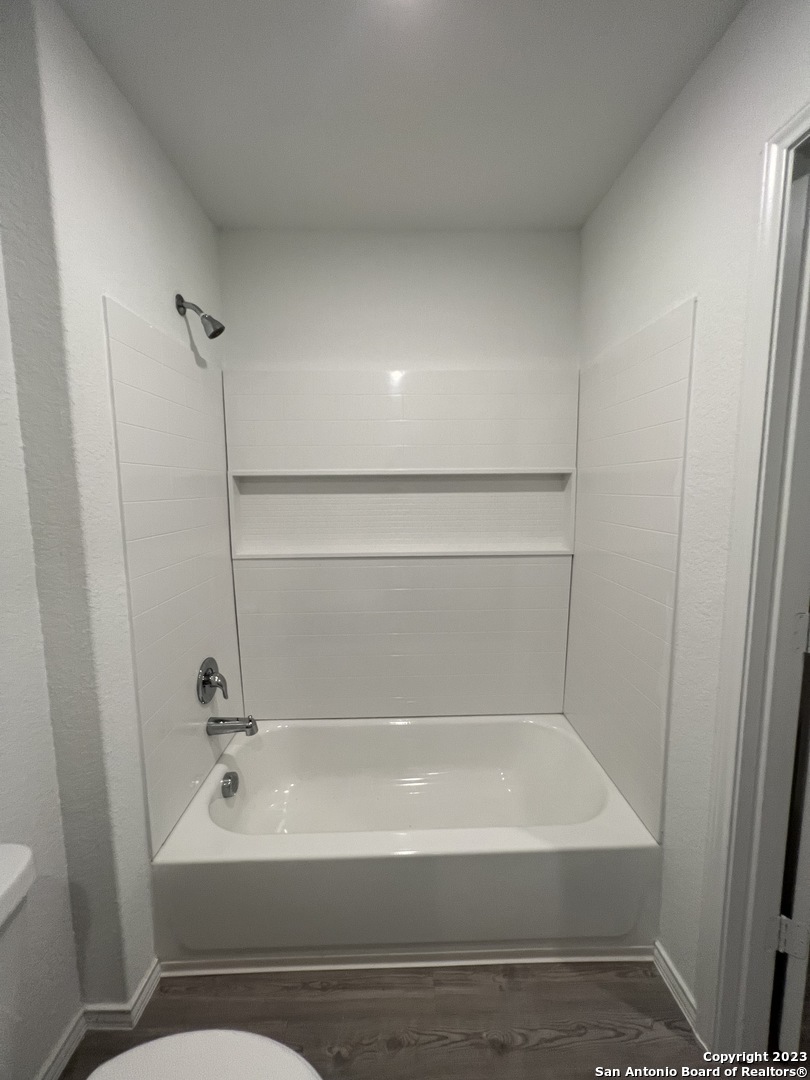 13819 Llama Place San Antonio, TX 78252 - Photo 34 of 37 a bathroom with a shower and a bath tub