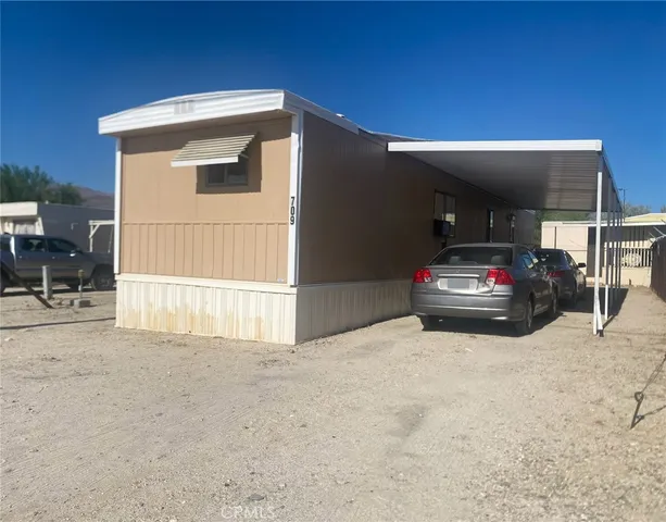 a view of a house with a wooden fence