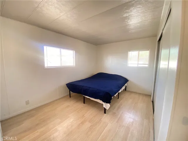 a bedroom with a bed and a chair