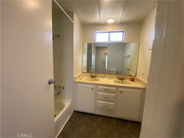 a bathroom with a granite countertop sink mirror and double