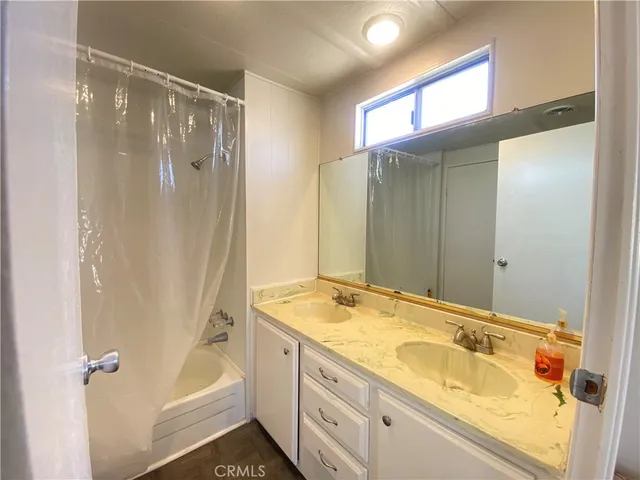 a bathroom with a tub sink and shower