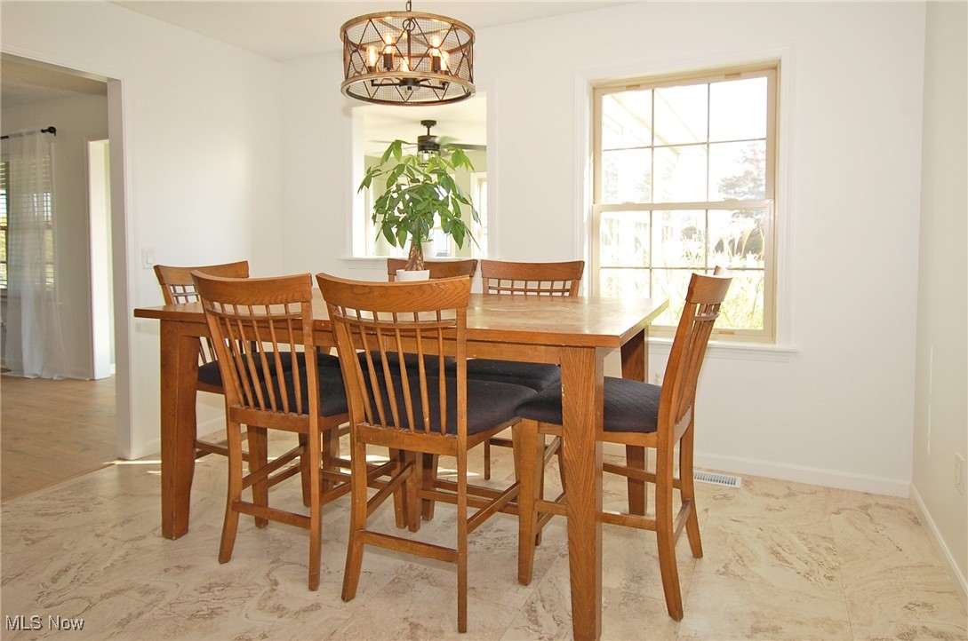 26875 W Road Wellington, OH 44090 - Photo 5 of 26 Dining area featuring an inviting chandelier and light wood-type flooring
