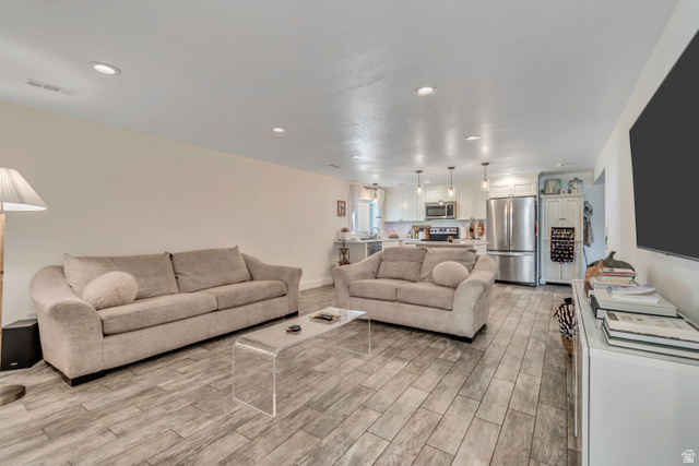 1071 Jamie-Matt Circle Layton, UT 84041 - Photo 8 of 28 Living area with wood tiled floors and recessed lighting