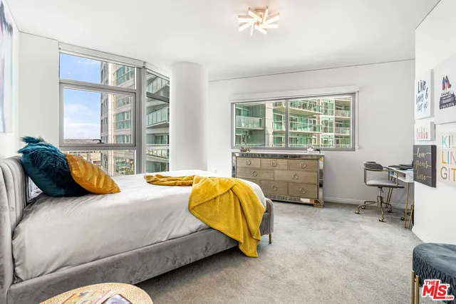 a bedroom with a bed and a desk