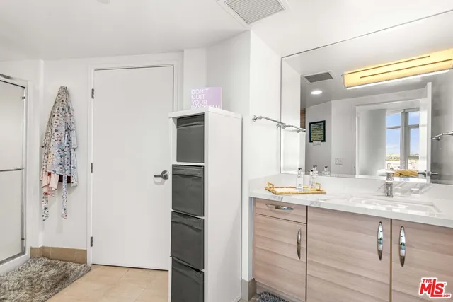 a bathroom with a double vanity sink and mirror