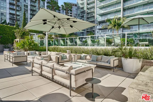 a view of a patio with couches and potted plants