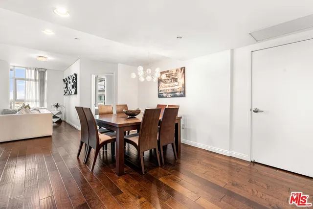 a view of a a dining room with furniture window and wooden floor