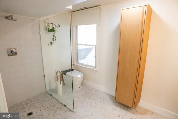 a bathroom with a shower and a sink
