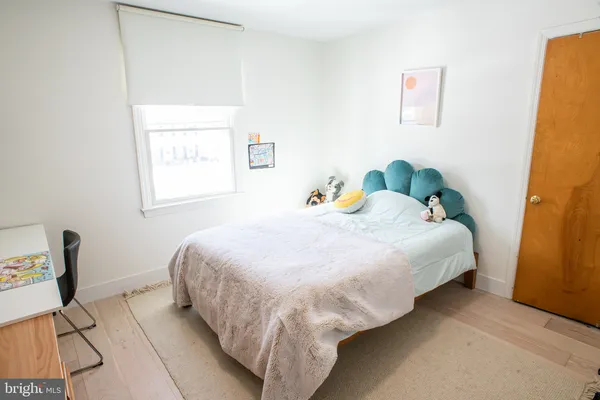 a bed sitting in a bedroom next to a window