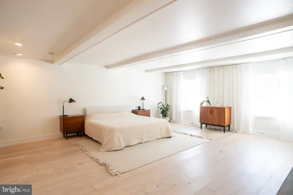 a bedroom with a bed and a couch