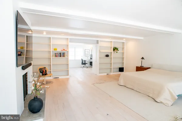 a large white bed in a white room