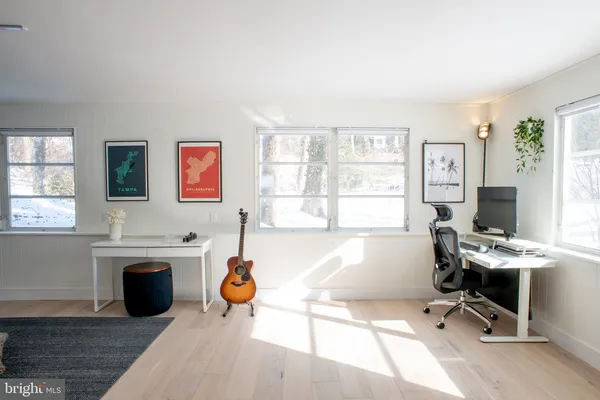 a living room with furniture a rug and a window