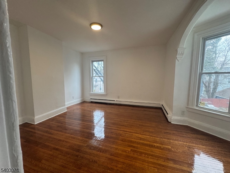 92 Cleveland Street Orange, NJ 07050 - Photo 14 of 16 a view of empty room with window and wooden floor