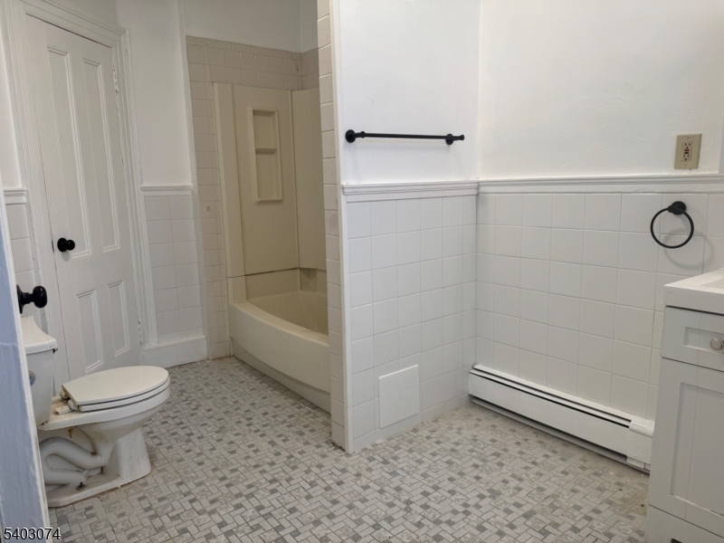 92 Cleveland Street Orange, NJ 07050 - Photo 8 of 16 a bathroom with a toilet and a shower