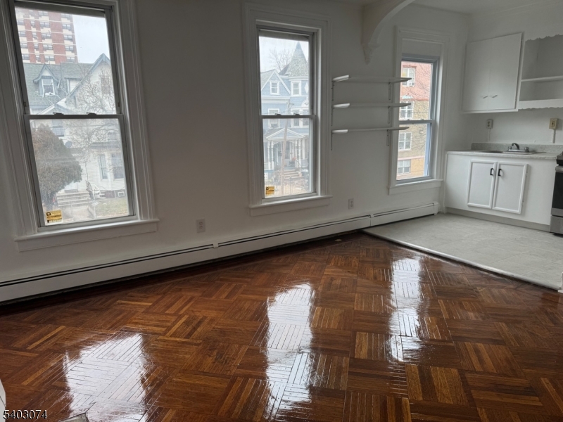 92 Cleveland Street Orange, NJ 07050 - Photo 9 of 16 a view of an empty room with windows