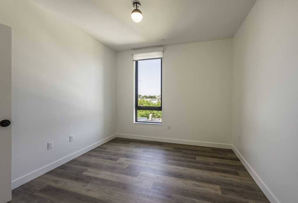 282 Bremen Street, Unit 237 Boston, MA 02128 - Photo 2 of 21 wooden floor in an empty room with a window