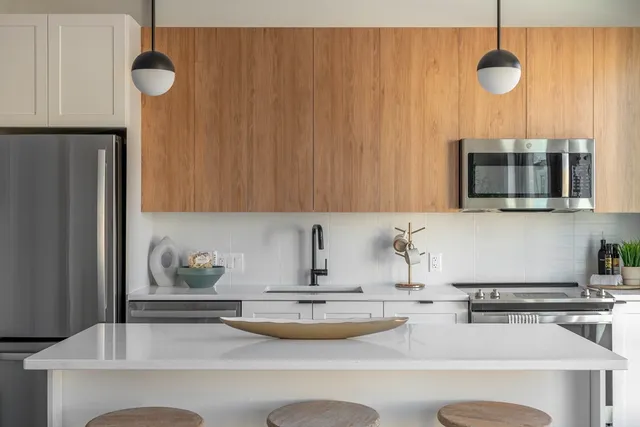 a kitchen with a sink a microwave and cabinets