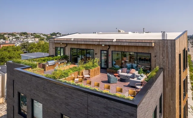 a view of a patio with dining table and chairs with wooden floor and fence
