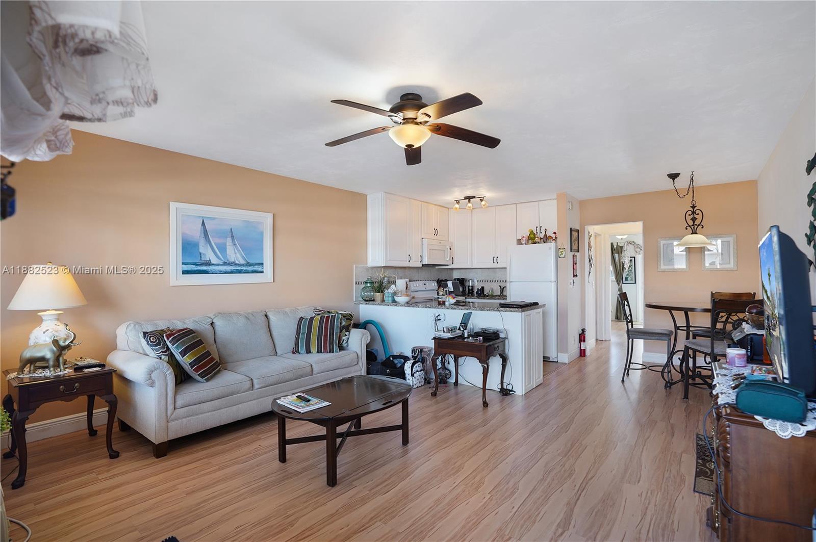 a living room with furniture kitchen view and a dining table