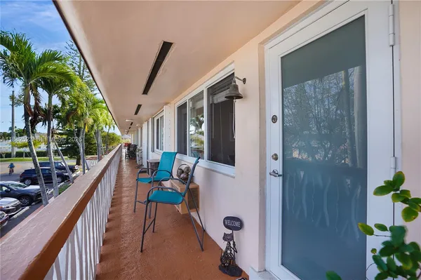 a balcony with furniture and potted plants