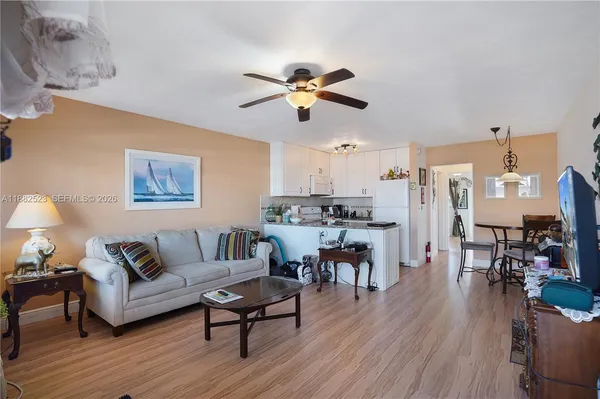 a living room with furniture kitchen view and a dining table