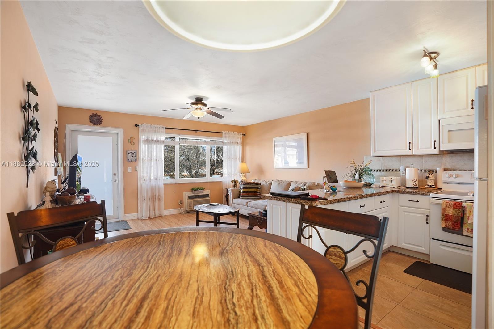 1000 Southwest 11th Avenue, Unit 17E Hallandale Beach, FL 33009 - Photo 5 of 18 a view of a workspace with furniture and a window