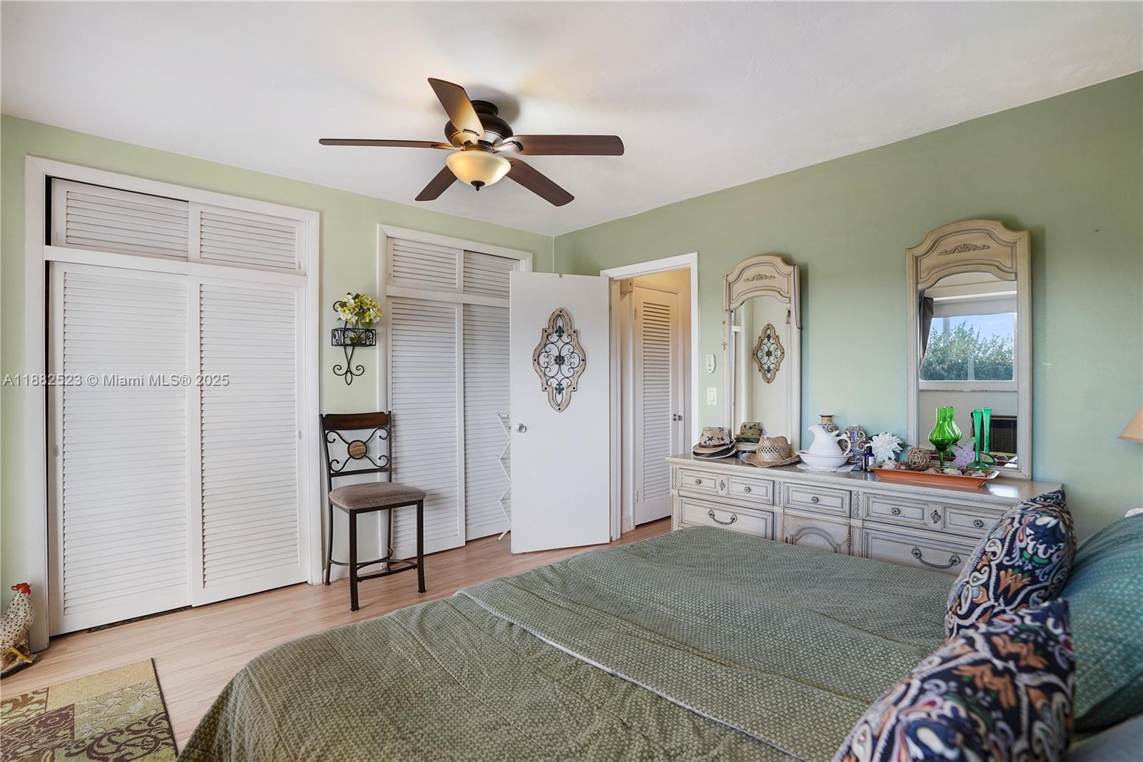 1000 Southwest 11th Avenue, Unit 17E Hallandale Beach, FL 33009 - Photo 10 of 18 a bedroom with a bed and a chandelier