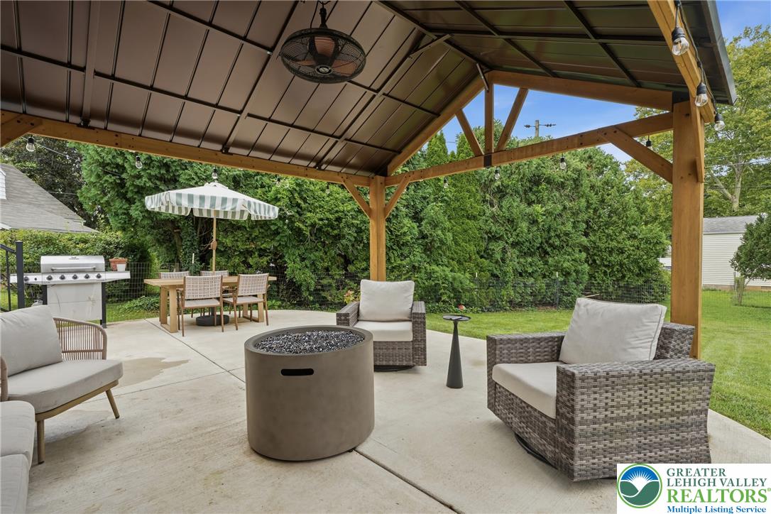 408 Maple Road Hellertown, PA 18055 - Photo 47 of 66 An inviting covered patio features concrete flooring and opens to a lush grassy backyard.