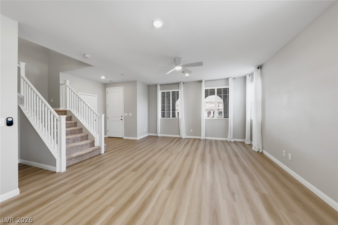 3564 Credere Lane Henderson, NV 89074 - Photo 5 of 40 Unfurnished living room featuring ceiling fan, light wood finished floors, and recessed lighting