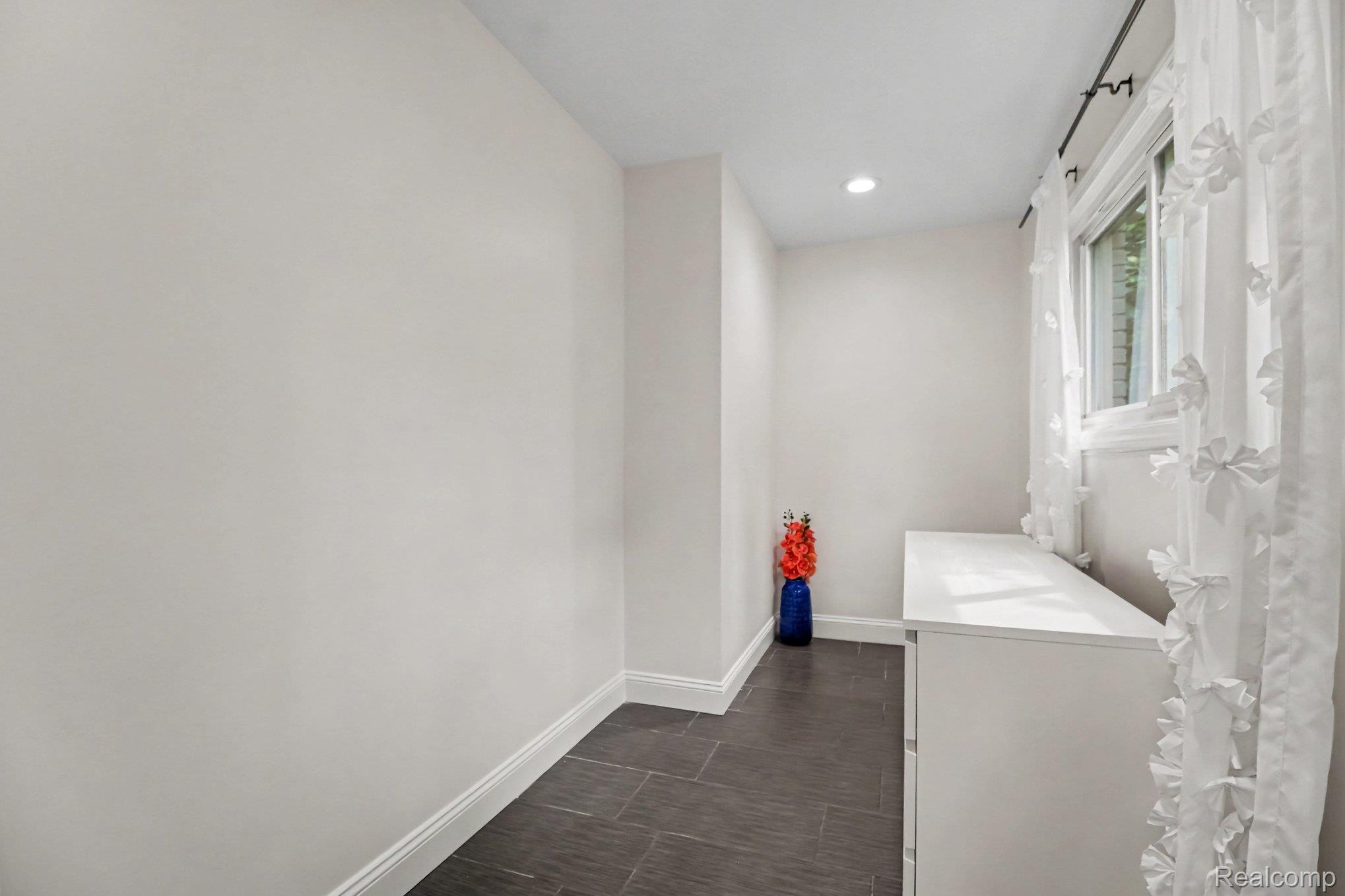 2373 Rutherford Road Bloomfield Hills, MI 48302 - Photo 14 of 28 Recessed lighting, tile flooring, window with natural light, white trim, and a built-in white cabinet