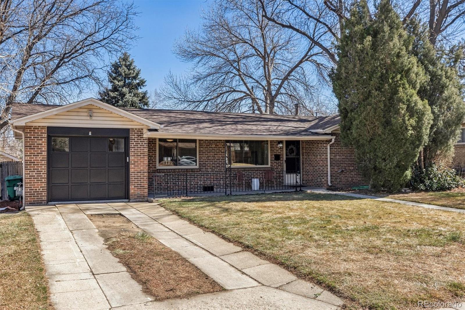 4170 North Lamar Street Wheat Ridge, CO 80033 - Photo 1 of 26 a front view of a house with a yard and garage