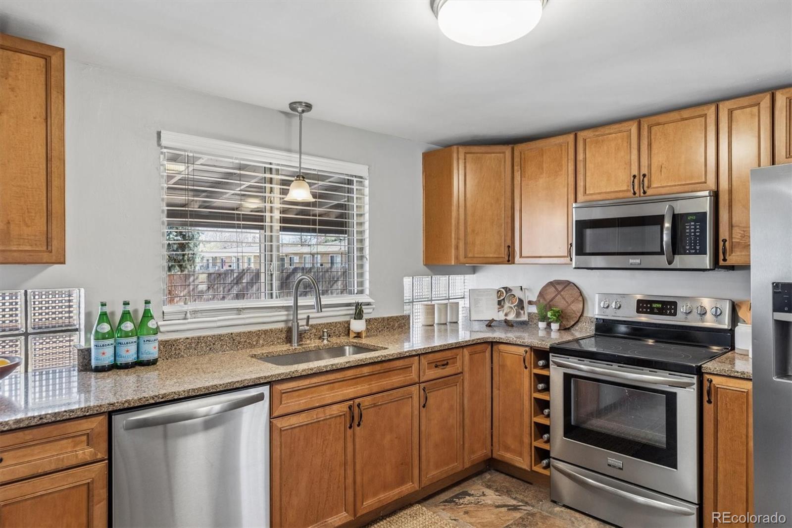 4170 North Lamar Street Wheat Ridge, CO 80033 - Photo 12 of 26 a kitchen with a sink stove top oven and microwave