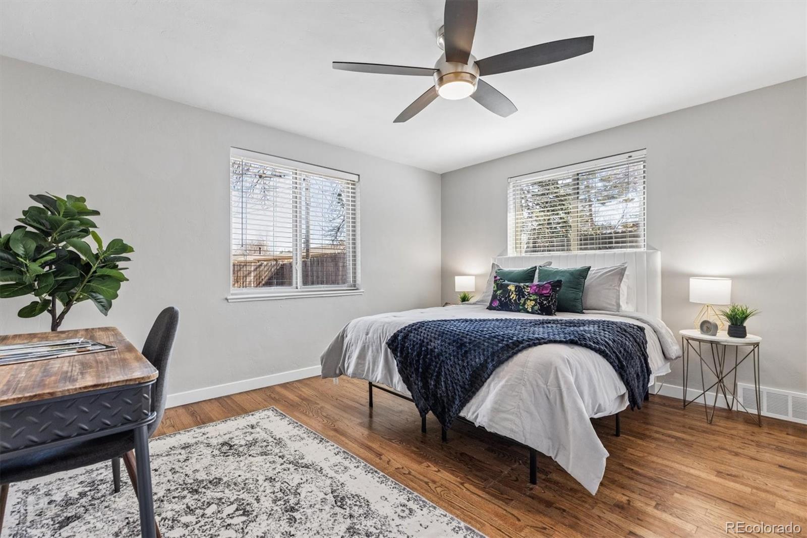 4170 North Lamar Street Wheat Ridge, CO 80033 - Photo 16 of 26 a bedroom with a large bed a chandelier and a window