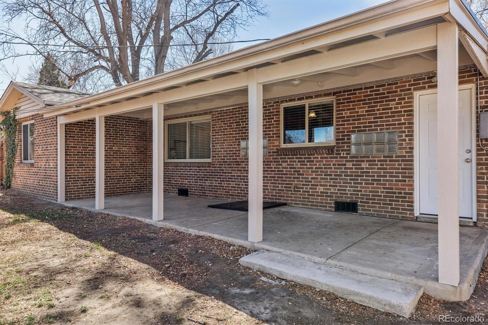 4170 North Lamar Street Wheat Ridge, CO 80033 - Photo 17 of 26 a view of a porch with a door and wooden fence