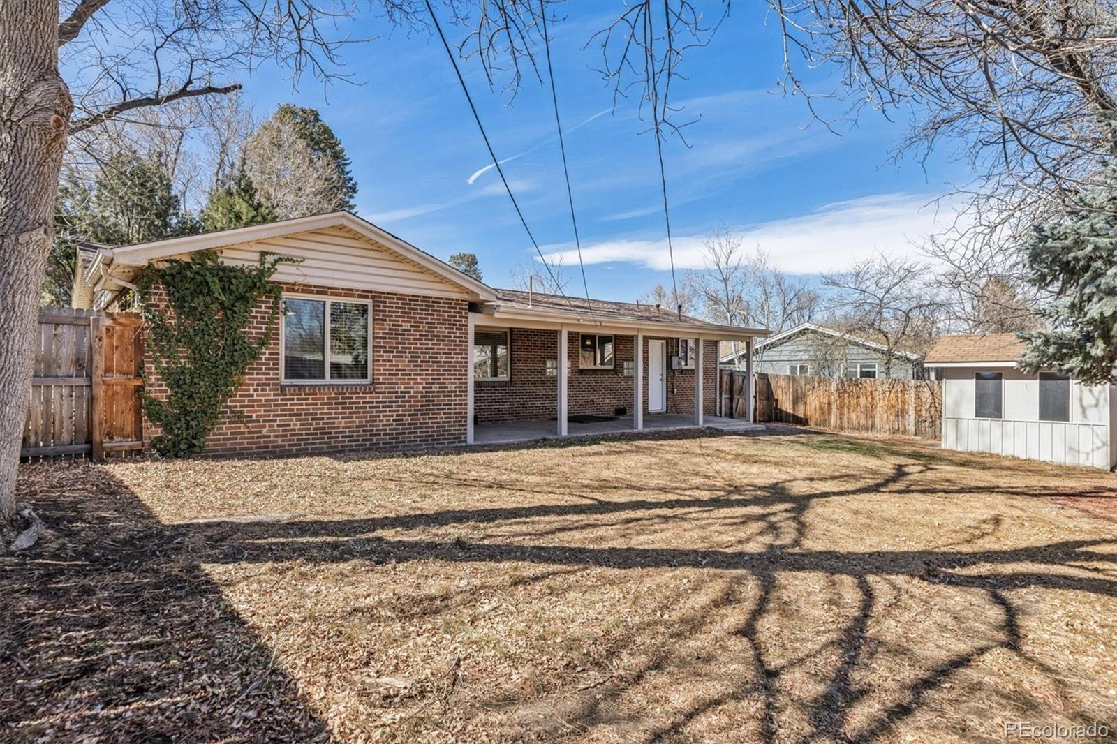 4170 North Lamar Street Wheat Ridge, CO 80033 - Photo 18 of 26 a front view of a house with a garden