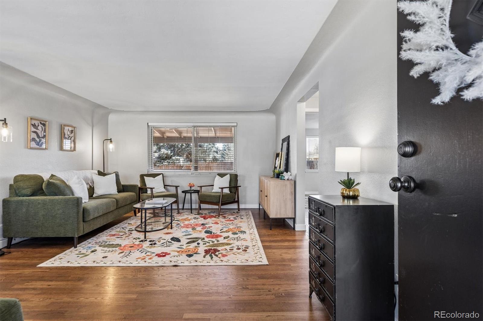 4170 North Lamar Street Wheat Ridge, CO 80033 - Photo 3 of 26 a living room with furniture window and wooden floor