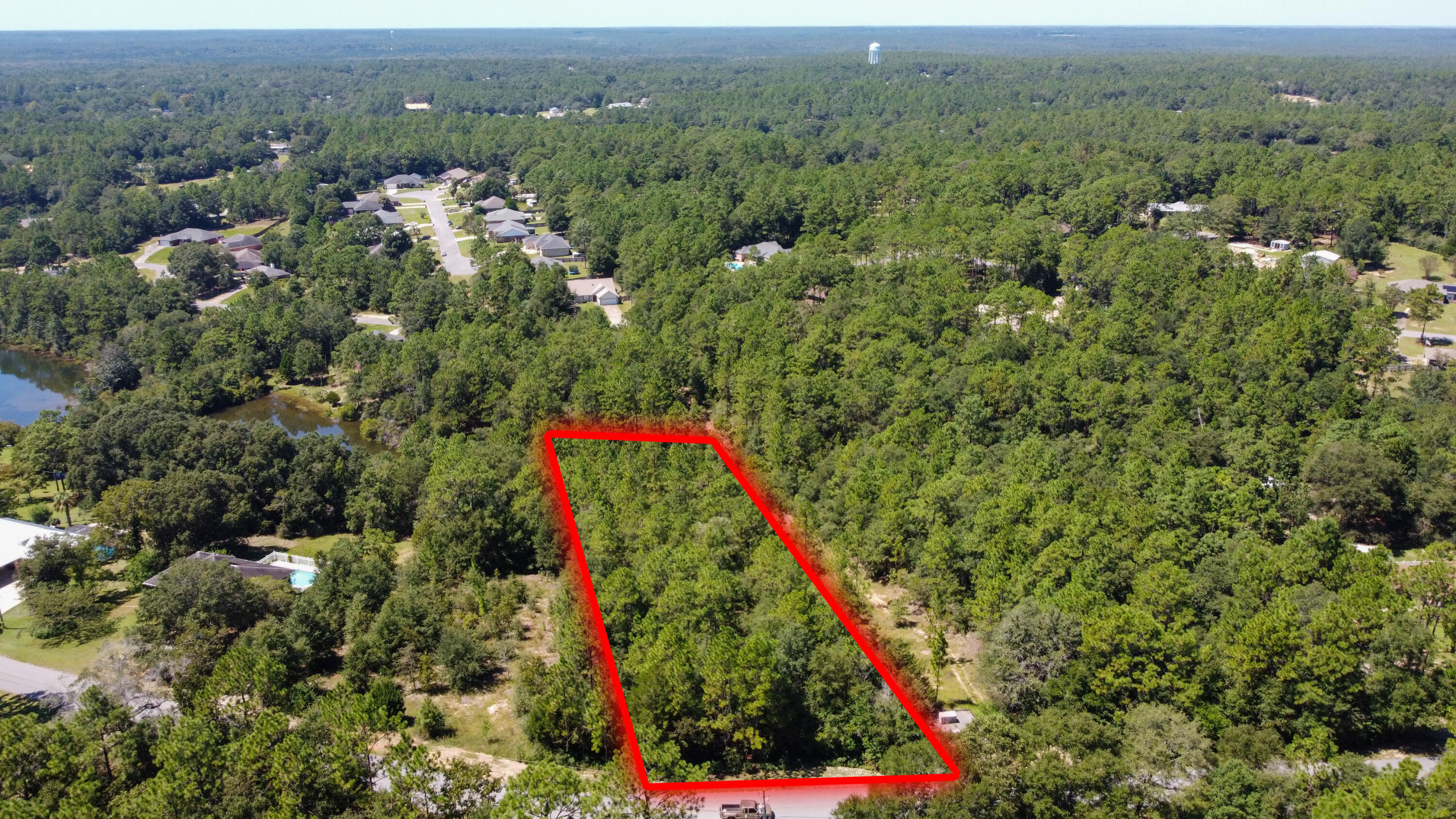 1-2 Ridge Lake Road Crestview, FL 32536 - Photo 1 of 9 an aerial view of a houses with a lush green hillside