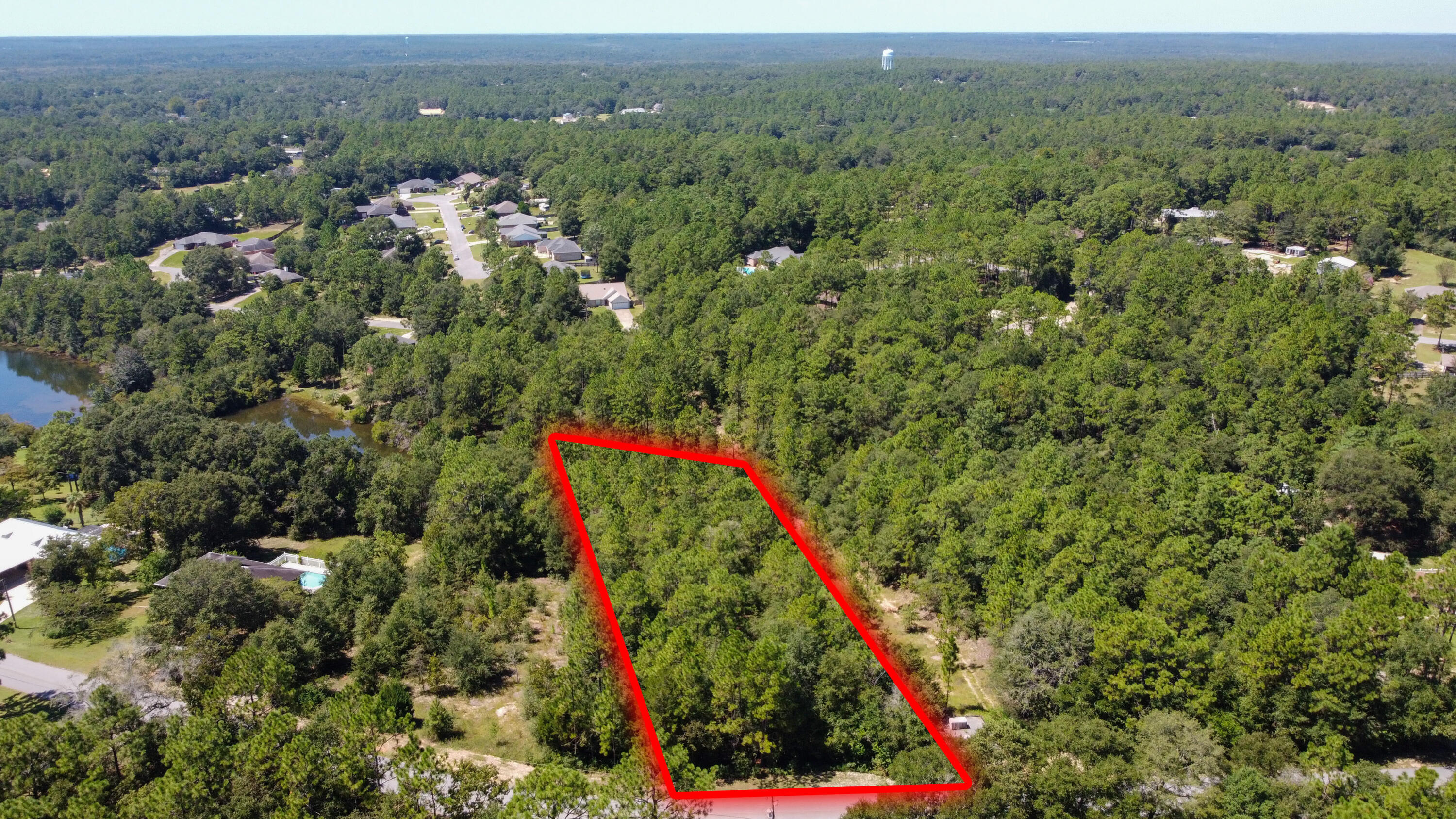 1-2 Ridge Lake Road Crestview, FL 32536 - Photo 2 of 9 an aerial view of a houses with a lush green hillside