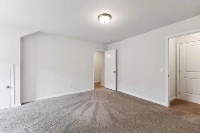 a front view of a house with a yard and a garage