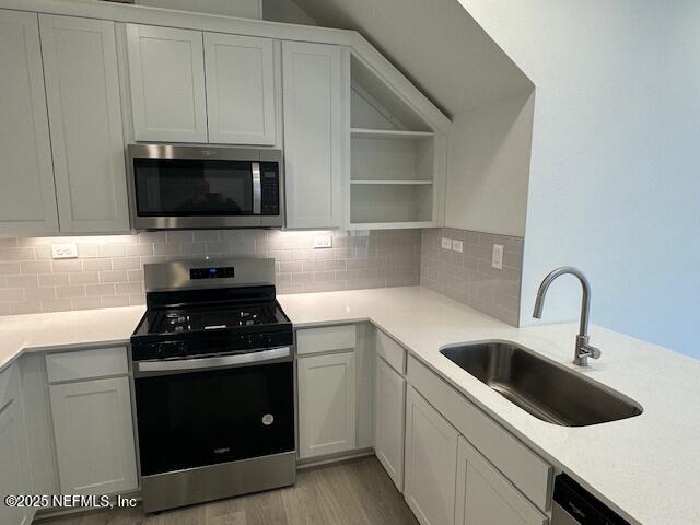 57 Camphor Laurel Road St. Augustine, FL 32092 - Photo 7 of 34 a kitchen with white cabinets a sink and appliances