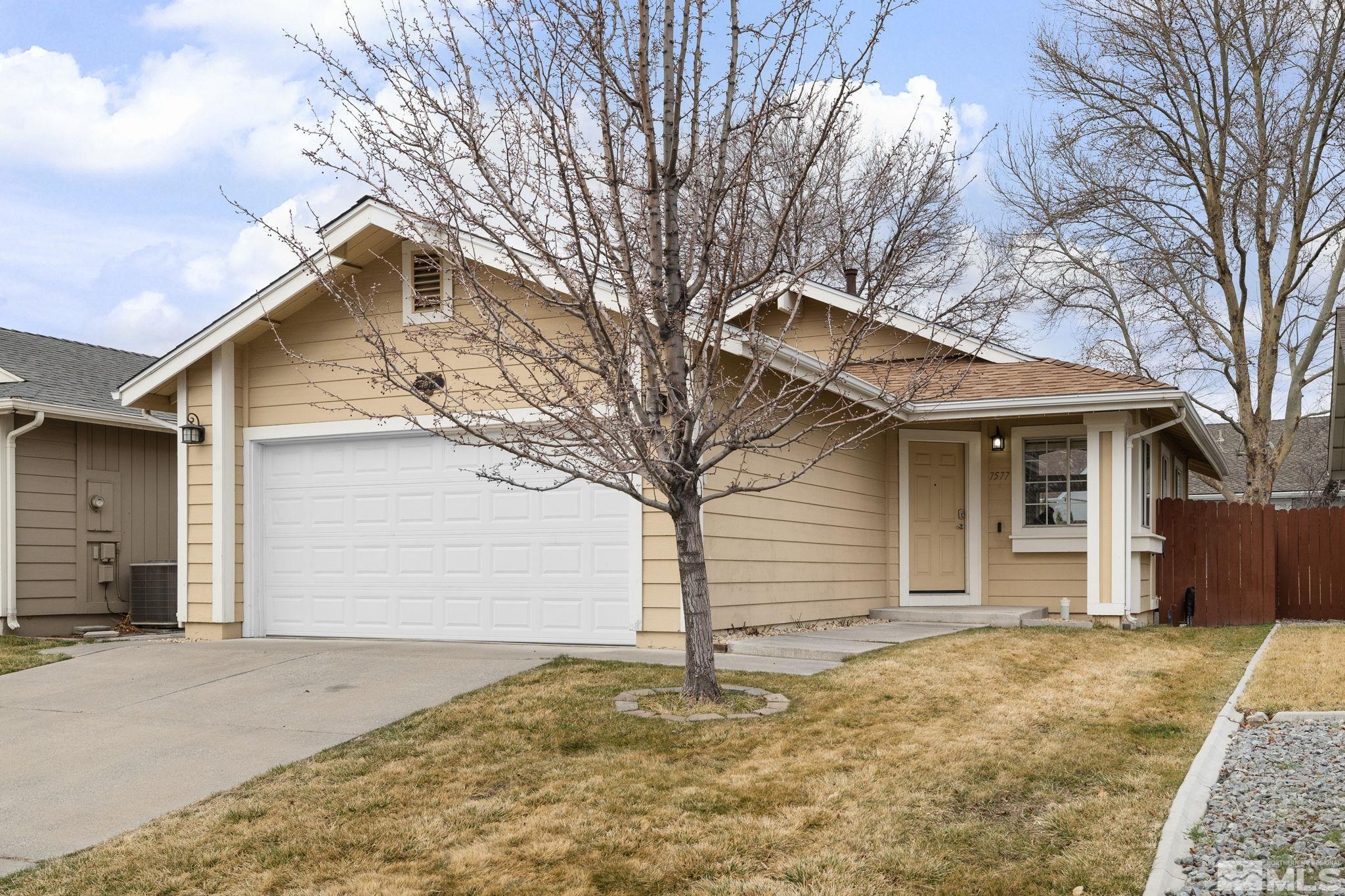 7577 Water View Way Reno, NV 89511 - Photo 1 of 20 a front view of a house with a yard and garage